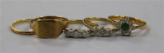 A 22ct gold band, two 18ct gold and gem set rings and two 9ct gold rings.